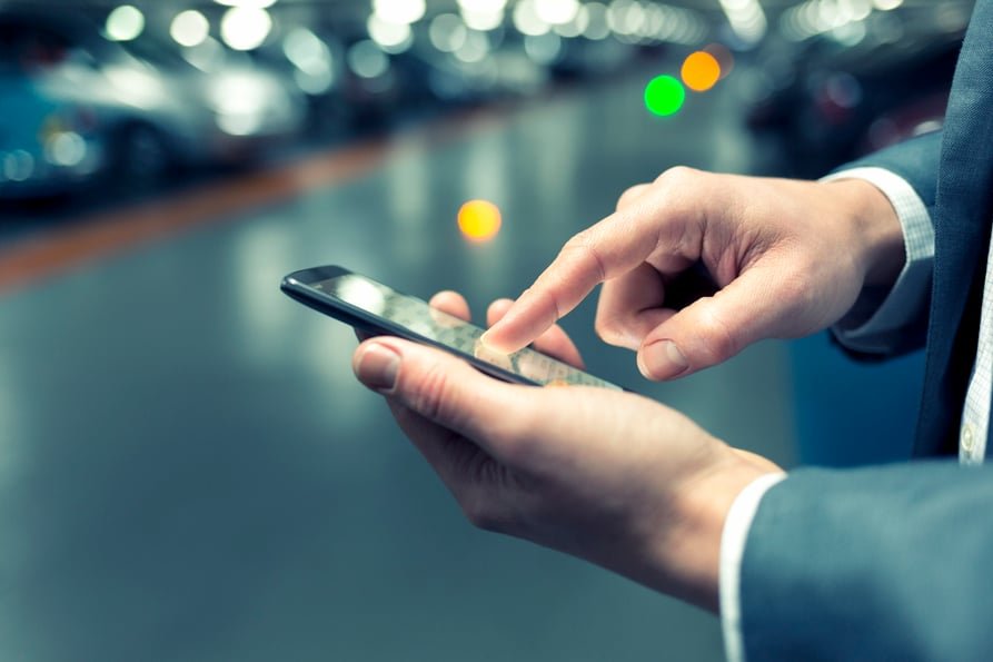 Picture of a businessman touching his smartphone.
